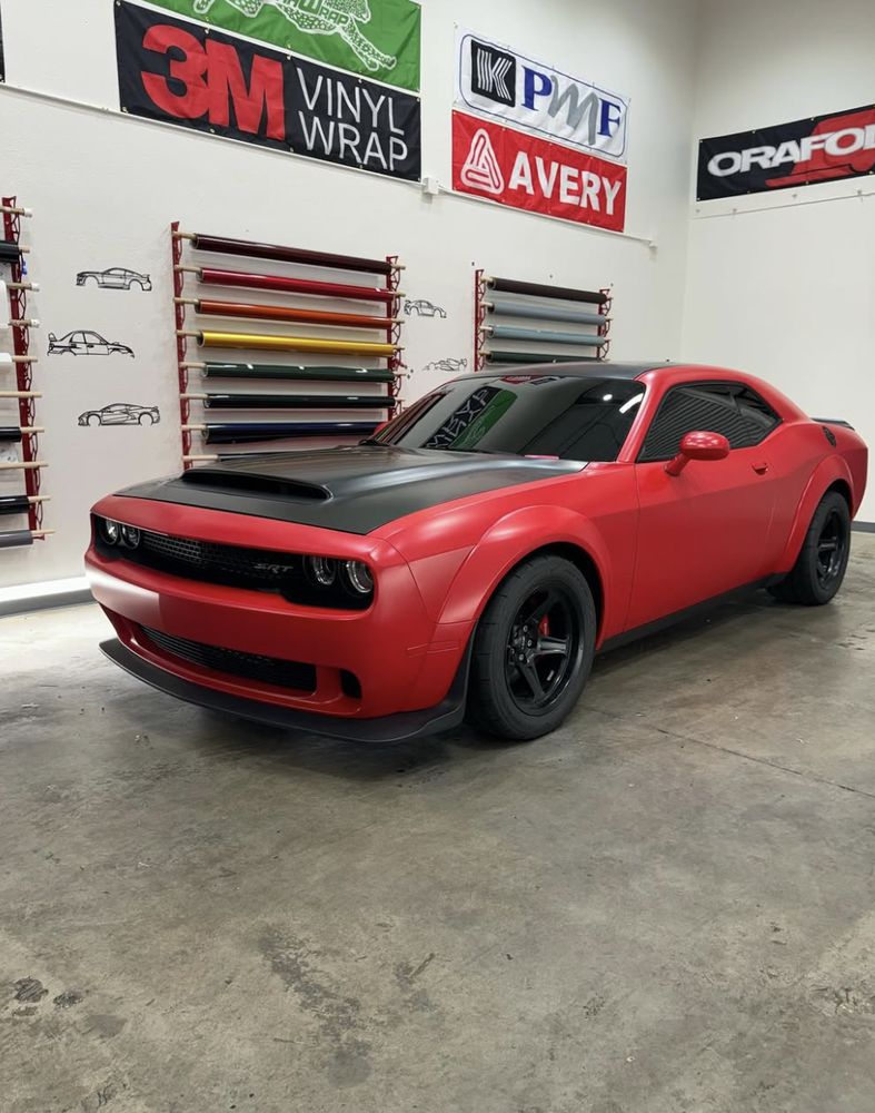 Matte red and black Dodge Challenger wrap in the shop