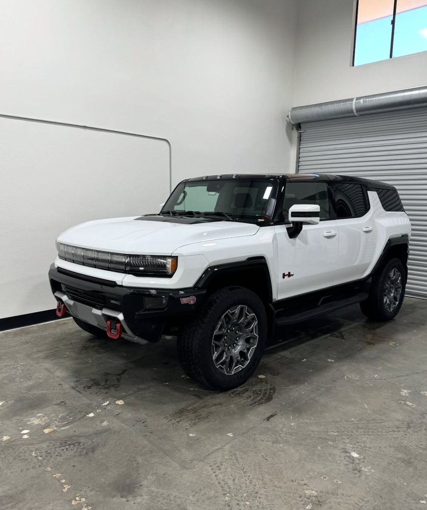 White GMC Hummer EV SUV in the shop