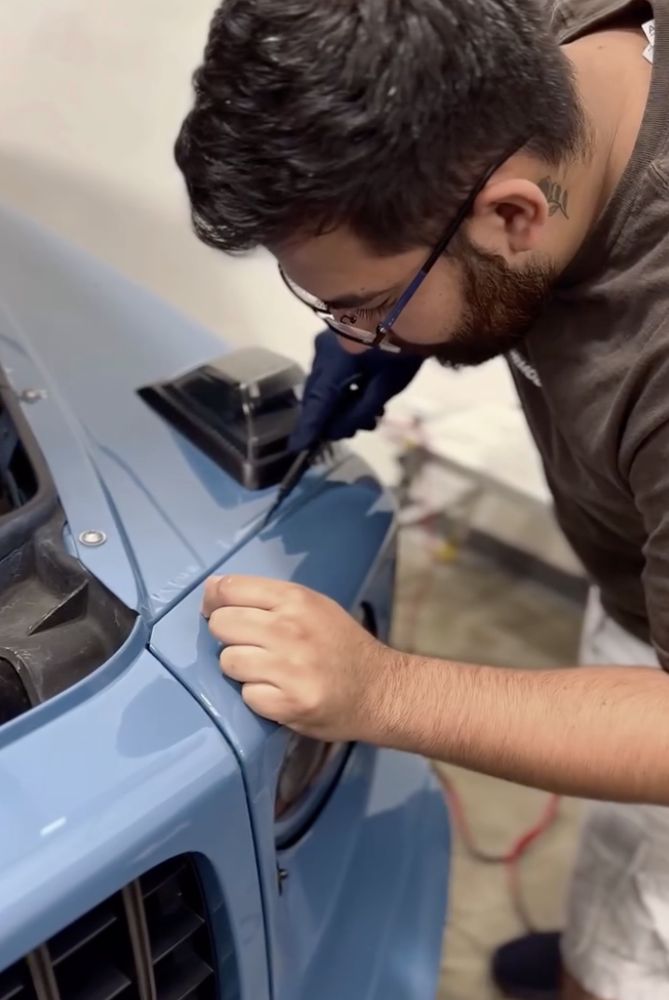 Technician installing paint protection film